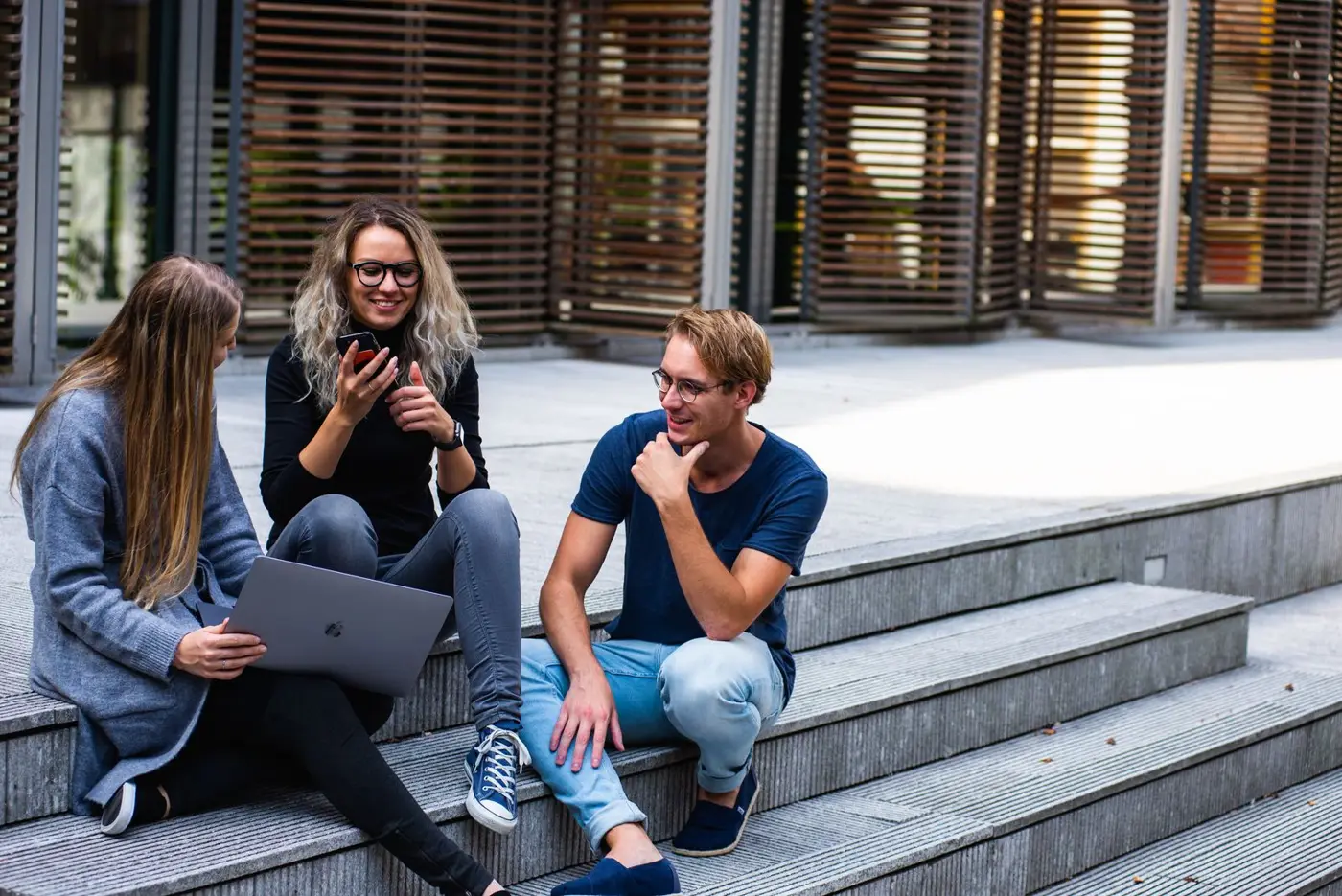Two students talking on campus steps