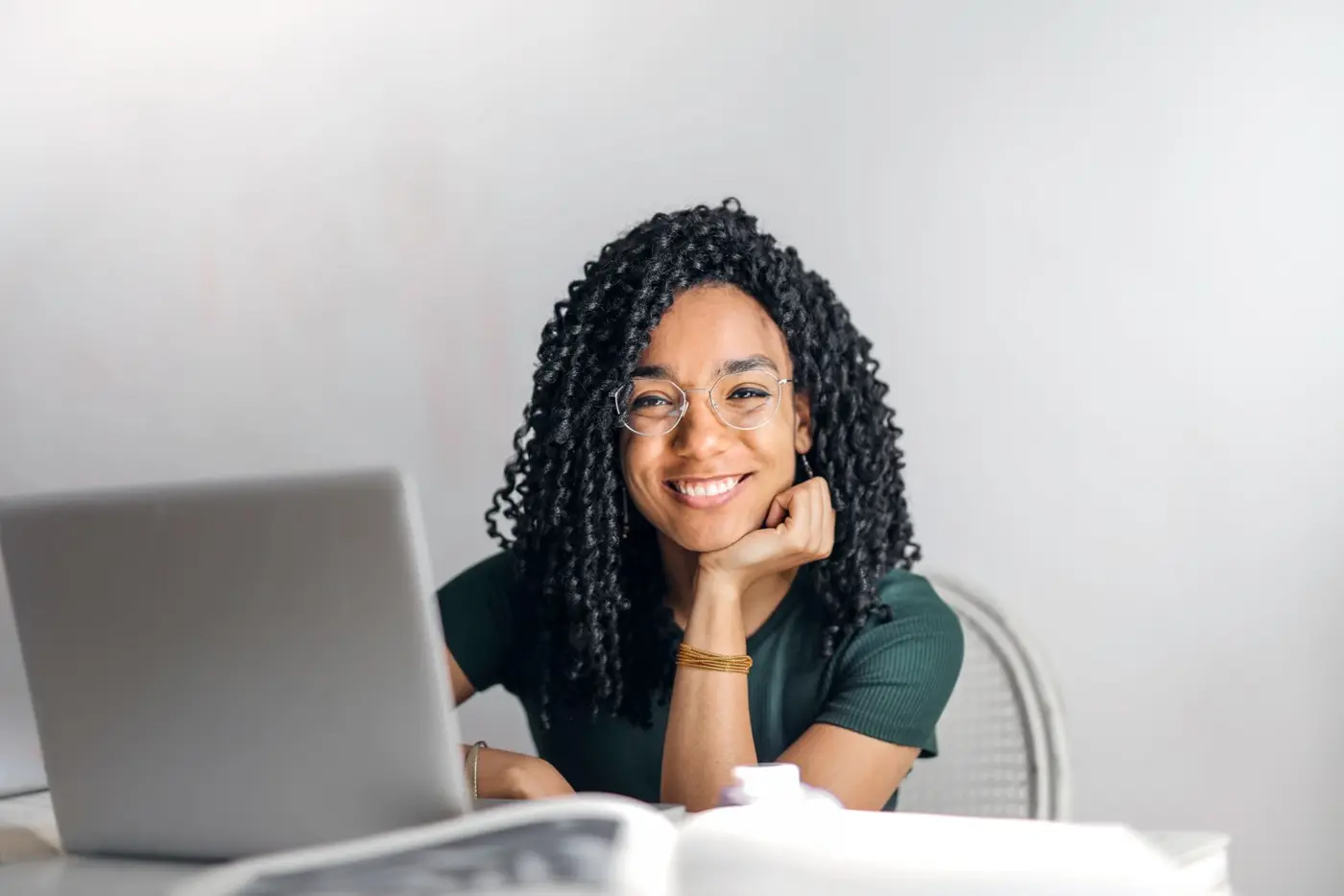 Smiling student working on a laptop